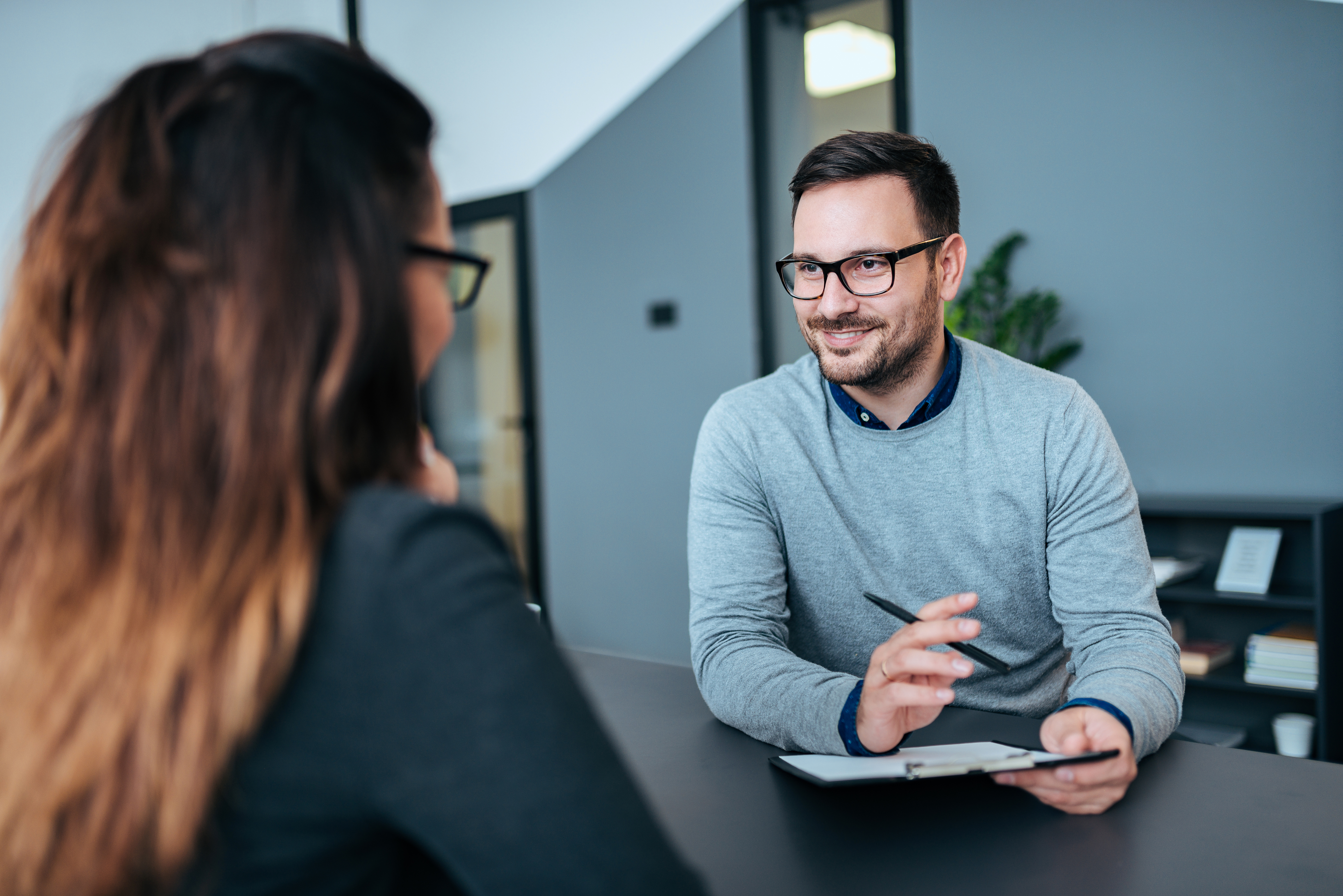 Female person having a job interview with a male recruiter.